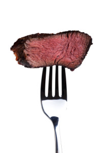 piece of a grilled steak on a fork