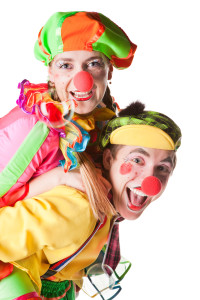 Two smiling clowns  isolated over a white background