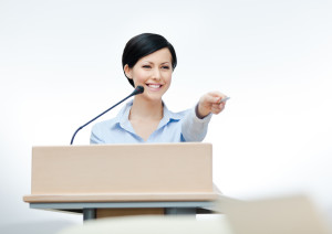 Female speaker at the board. Business conference